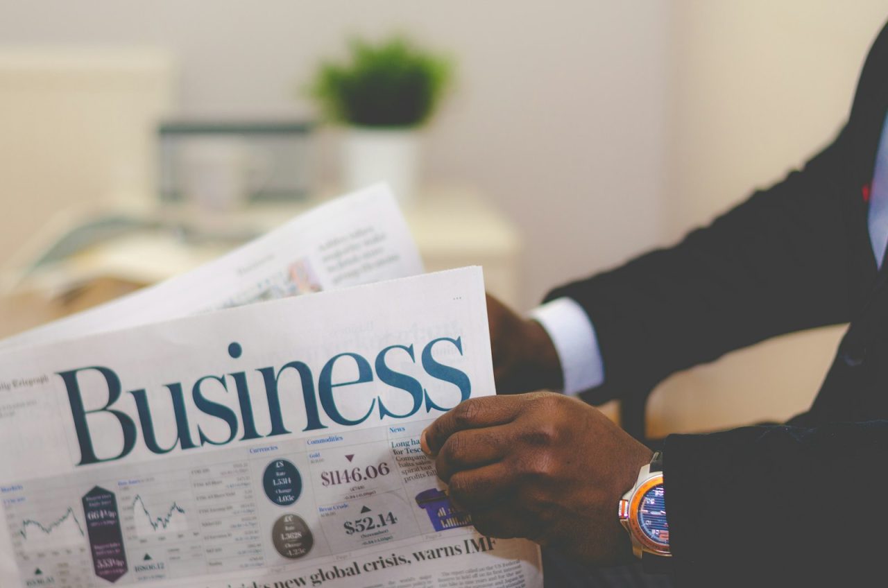 Press publications: a businessman reading the business section of a newspaper